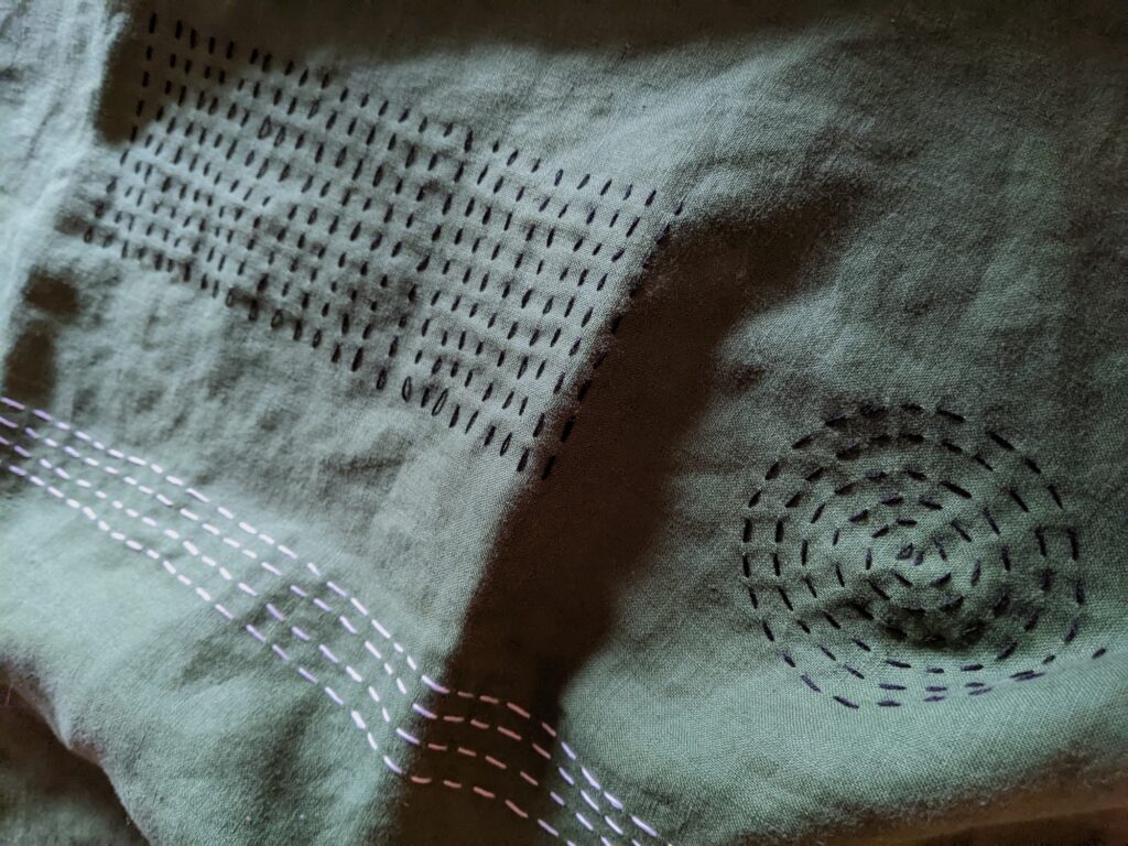 Sashiko stitching added in parallel rows and spirals to adorn home decor